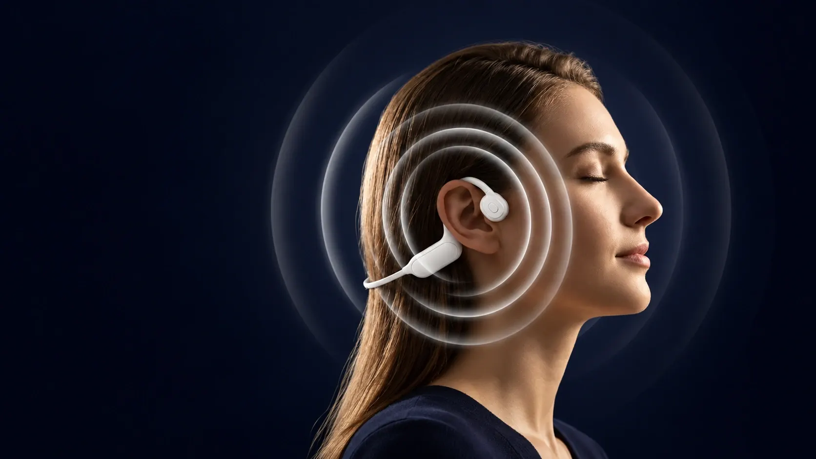 A woman wearing High Frequency Headphones, with silver rings illustrating vibration